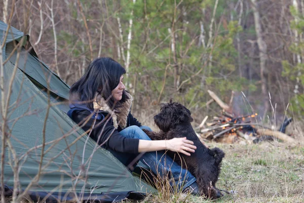 Woman with a dog camping — Stock Photo, Image