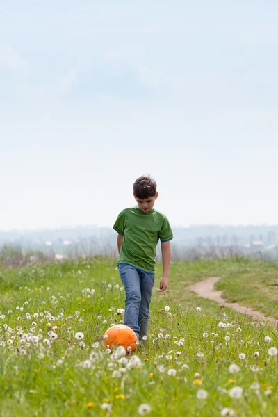 Cute boy with football outdoors — Stock Photo, Image