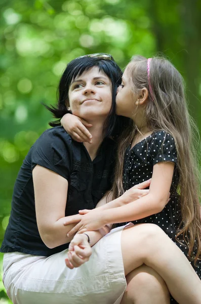 Tochter küsst ihre Mutter — Stockfoto