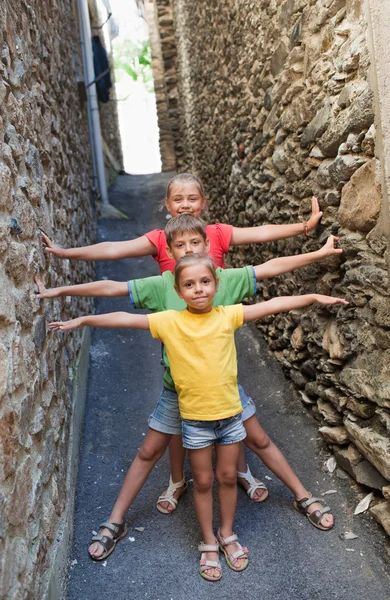 Funny children on narrow street — Stock Photo, Image