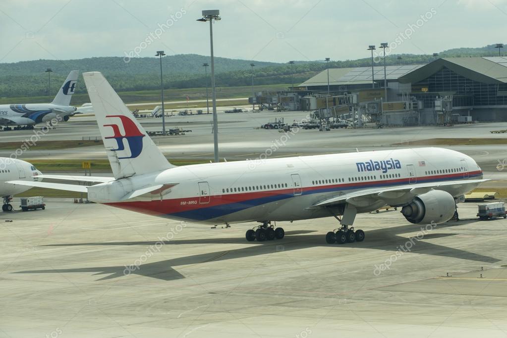 KUALA LUMPUR INTERNATIONAL AIRPORT - MARCH 17: Boeing 777-200ER (9M-MRG) Malaysia Airlines plane park at the apron and prepares the plane for the flight on March 17, 2014 in KLIA, Sepang, Malaysia.