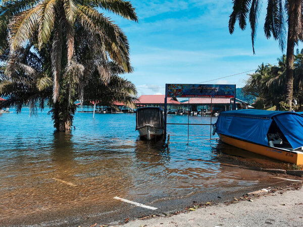 TASIK KENYIR, TERENGGANU, MALAYSIA-CIRCA JUNE 2022: Tourists boats anchored near the Kenyir Lake in Terengganu, Malaysia.