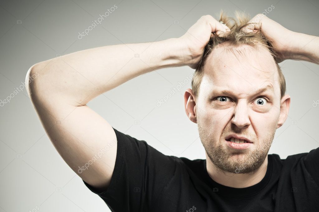 Caucasian Man Pulling Out Hair WIth Frustration