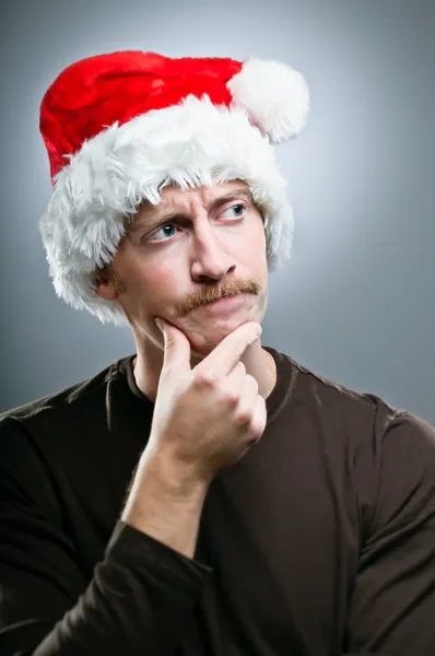 Man Wearing Santa Hat Thinking Of What Gifts To Give — Stock Photo, Image