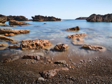 Rocks and sea in long exposure in Menorca island, Spain