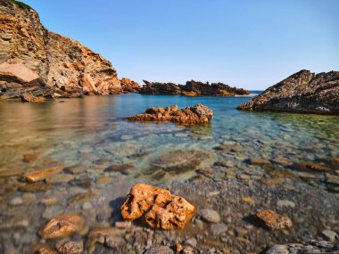 Rocks and sea in long exposure in Menorca island, Spain