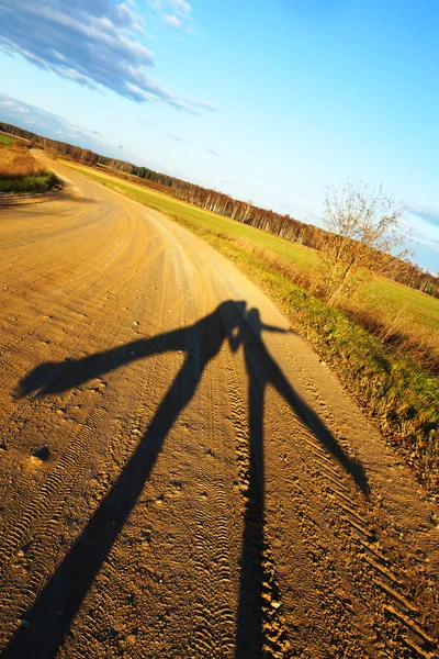Two shadows on the background of autumn road — Stock Photo, Image
