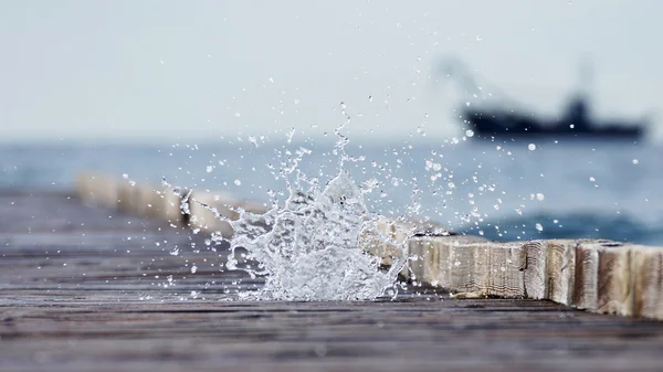 Drewniane molo prowadzącego do błękitnego morza i kaskady morze spr — Zdjęcie stockowe