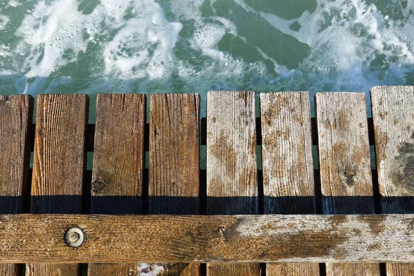 Wooden pier leading into the blue sea — Stock Photo, Image