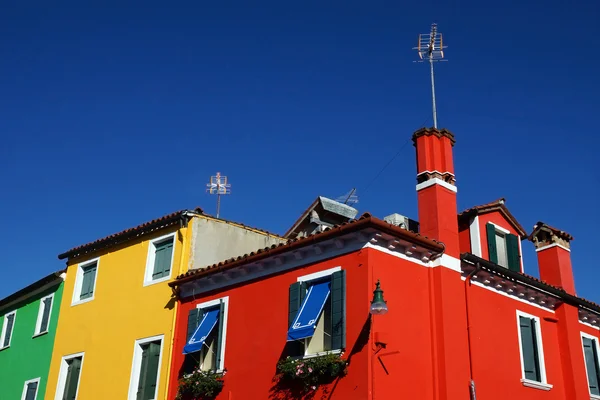 Colored facade of the island of Burano in the background of blue — Stock Photo, Image