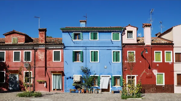 Colored facade of the island of Burano in the background of blue — Stock Photo, Image