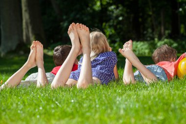 Kids relaxing in park clipart