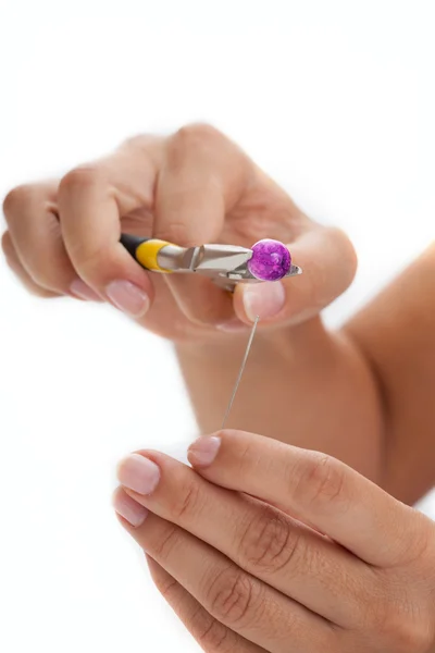 Girl making an earring — Stock Photo, Image