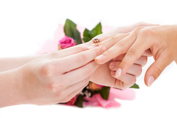 Man putting a golden ring on woman's hand — Stock Photo, Image