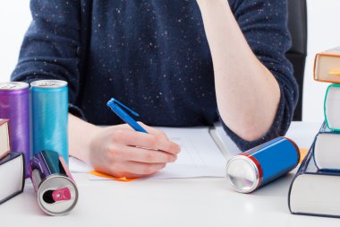 Overworked student with energy drinks clipart