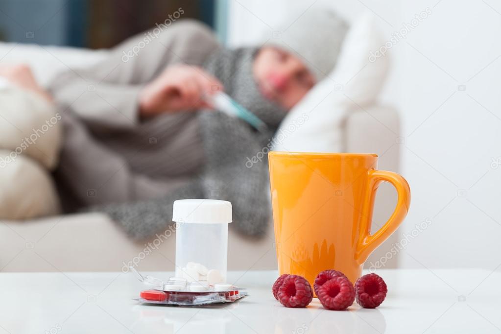 Man in bed having a cold