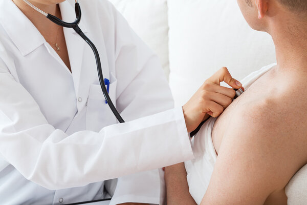 Doctor auscultating a patient