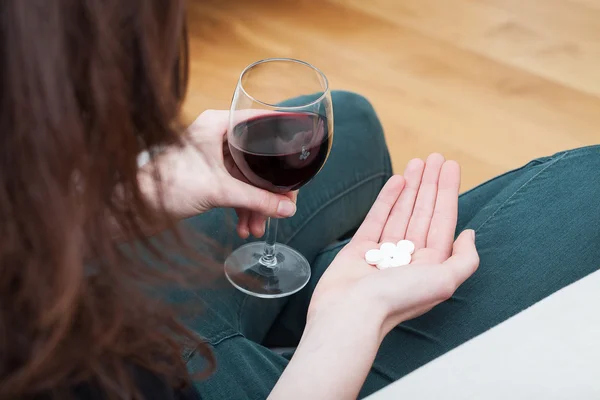 Woman with drugs and glass of wine — Stock Photo, Image