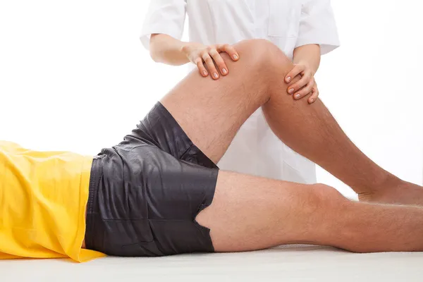 Physiotherapist massaging a leg — Stock Photo, Image