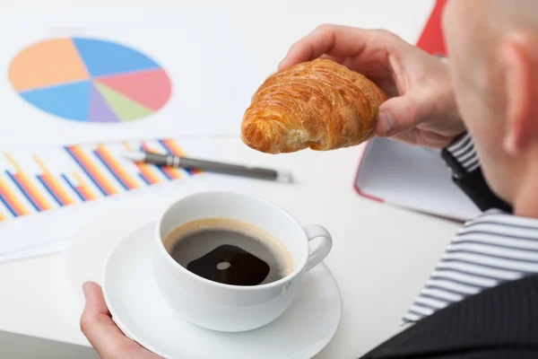 Man in suit with coffee and roll — Stock Photo, Image