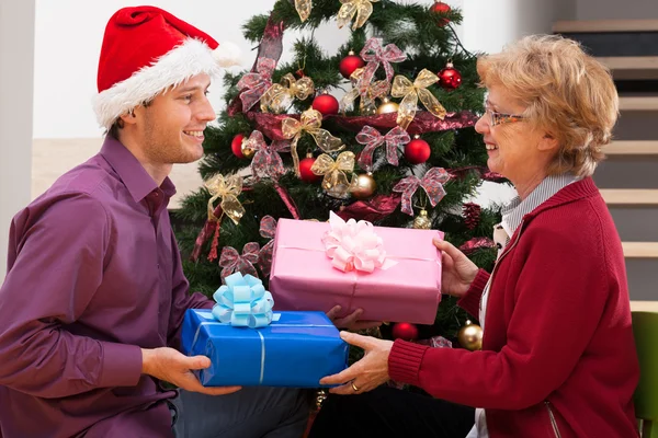 Christmas presents for mother from son. — Stock Photo, Image