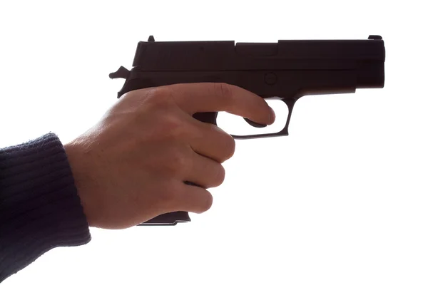 Рука, держащая пистолет — стоковое фото