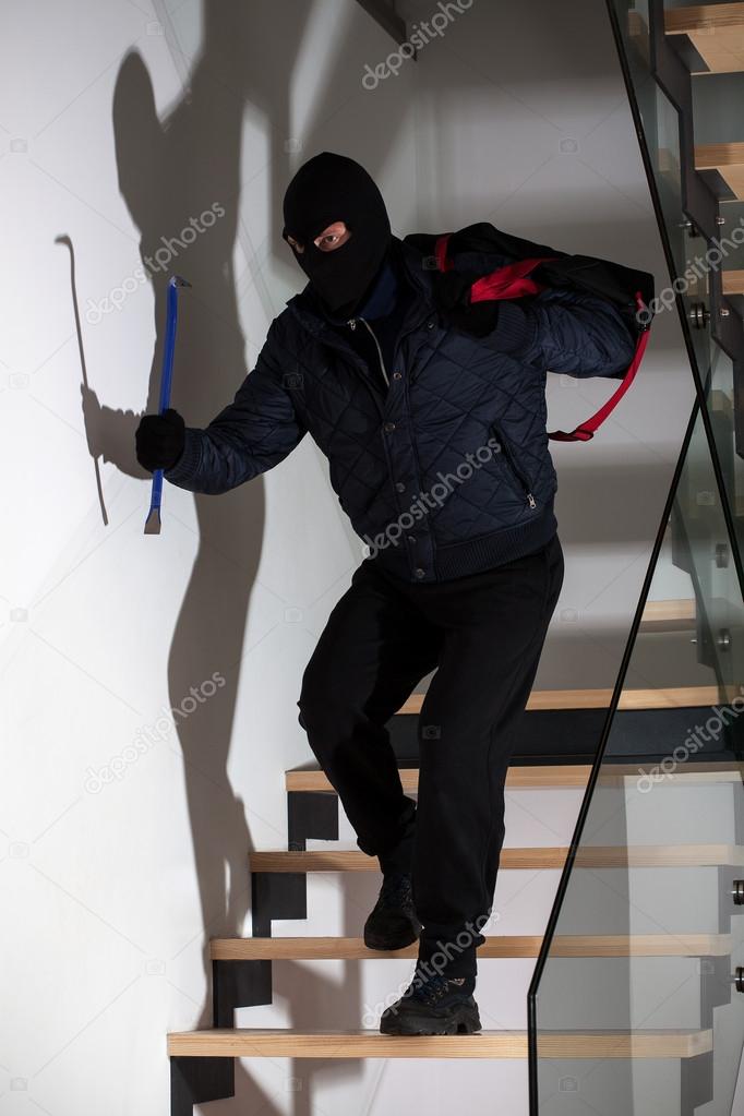 Bandit with crowbar on stairs