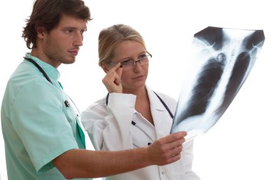 Radiologist showing x-ray to another doctor clipart