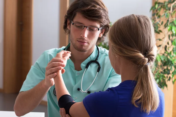 Orthopäde untersucht Ellbogen — Stockfoto