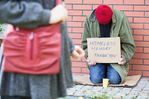 Woman passing poor man — Stock Photo, Image