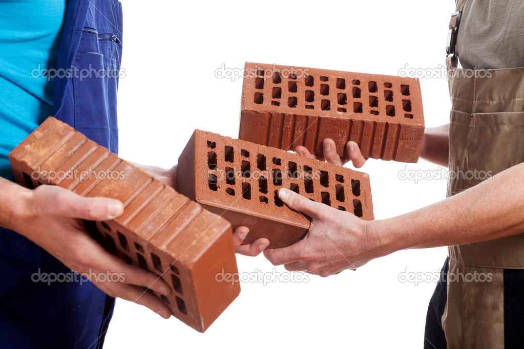 Manual workers giving a bricks