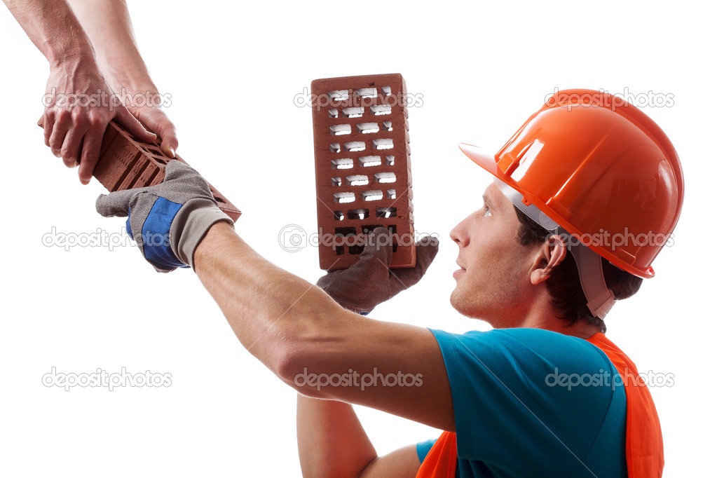 Man in hard hat building a house