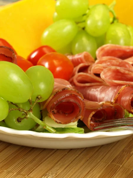 Dish with ham and grapes, closeup — Stock Photo, Image