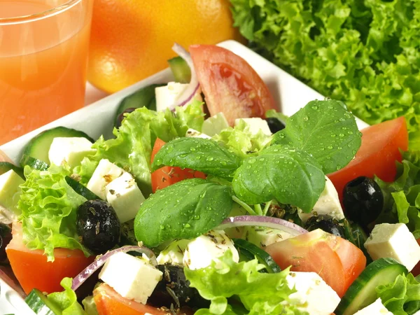 Close-up of greek salad with basil — Stock Photo, Image