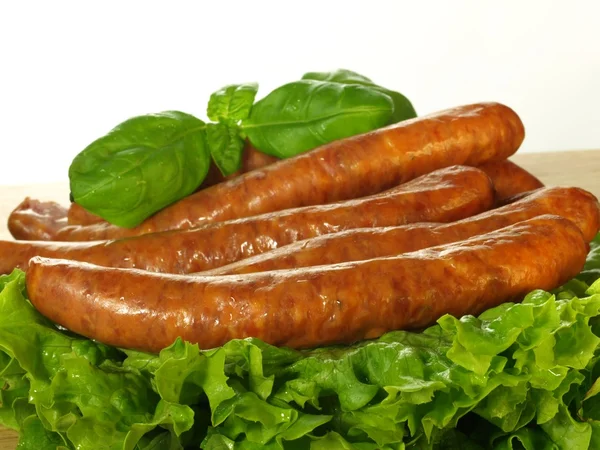 Sausage with lettuce, closeup — Stock Photo, Image