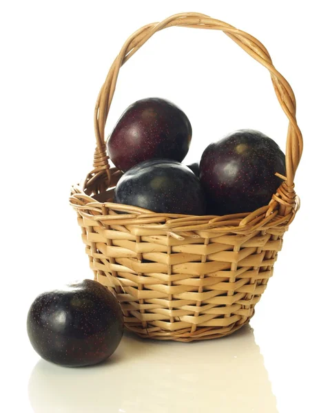 Plums in wicker, isolated — Stock Photo, Image
