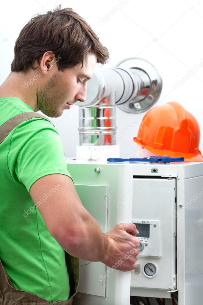 Handyman repairing boiler