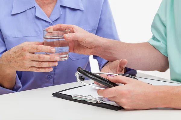 Läkare ger glas vatten — Stockfoto