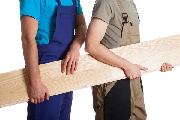 Builders with board — Stock Photo, Image