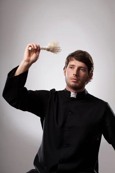 Clergyman with aspergillum — Stock Photo, Image