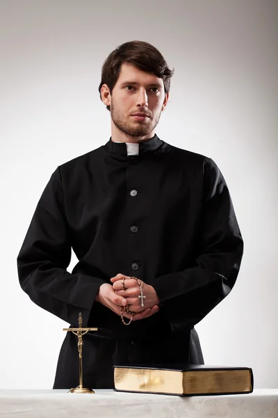 Handsome reverend with crucifix and the Bible — Stock Photo, Image