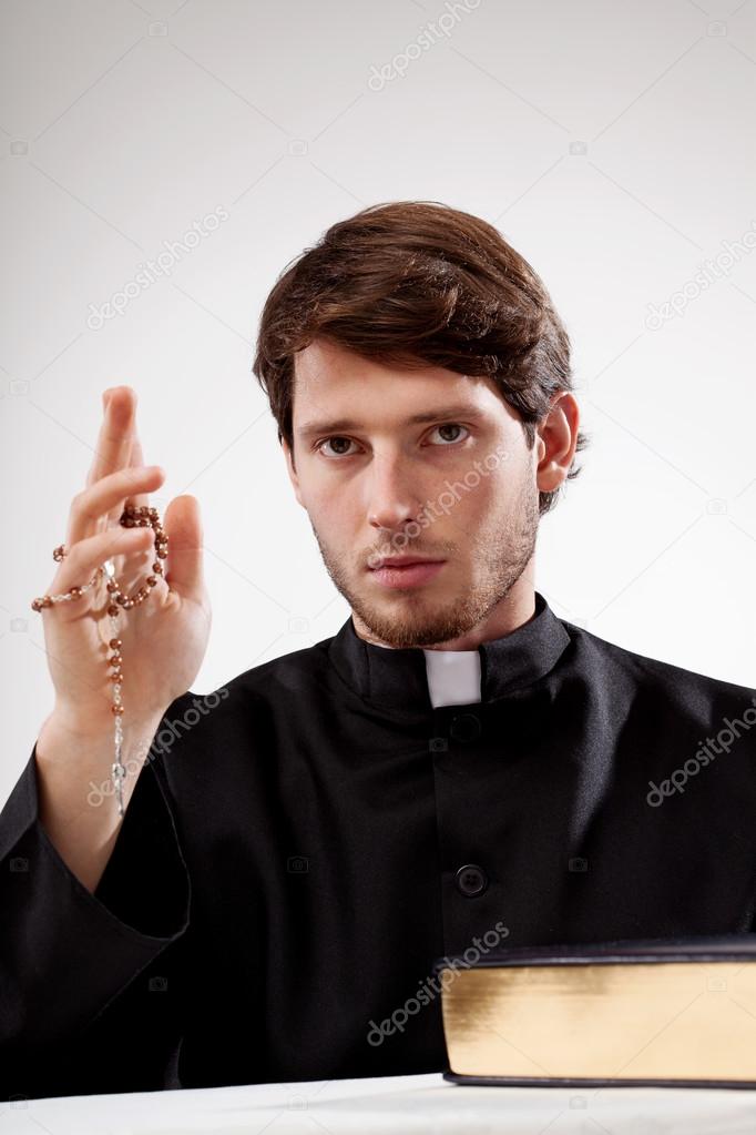 Catholic man with rosary in hand