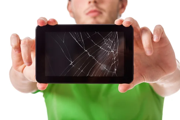 Young man holding broken tablet — Stock Photo, Image