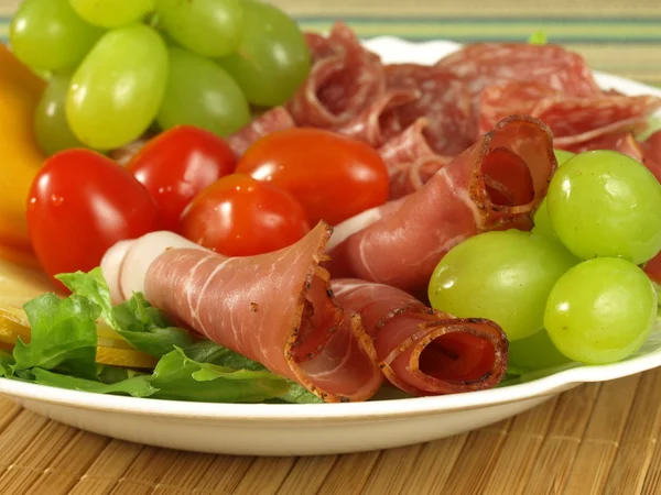 Ham, tomatoes and grapes — Stock Photo, Image