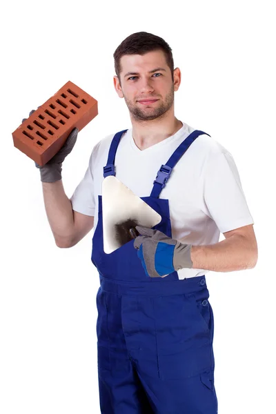 Builder standing with brick and spatula — Stock Photo, Image