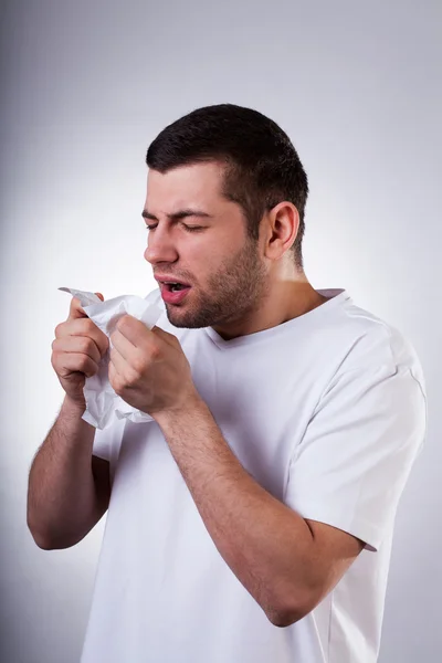 Sick man sneezing in wipe — Stock Photo, Image