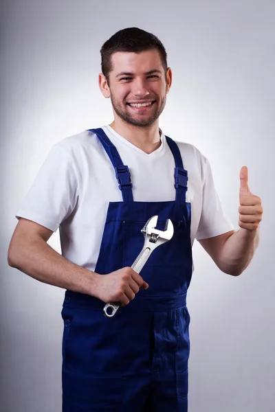 Happy handyman with wrench — Stock Photo, Image