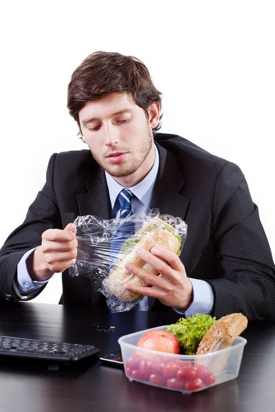 Empresário comendo sanduíche — Fotografia de Stock