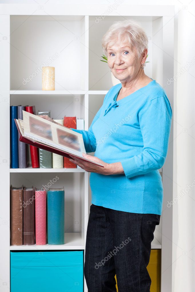 Elderly woman looking through photo album