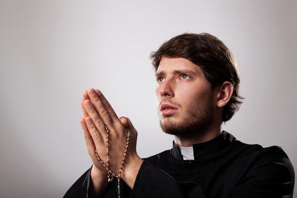 Priest with rosary